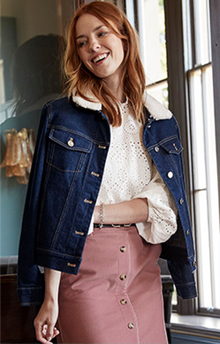 Woman wearing the Cotton Traders Sherpa Collar Denim Jacket and Brontë Broderie Trim Lace Blouse