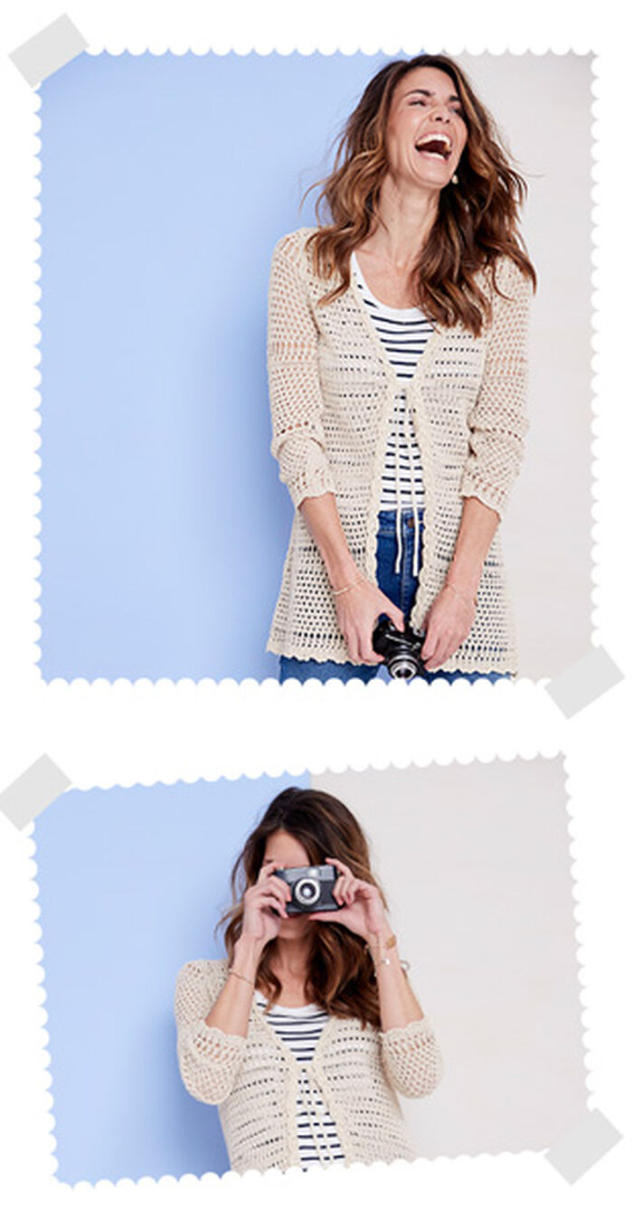 Two images of a woman wearing a blue and white pin stripe t-shirt, Cotton Traders crochet cardigan and blue denim shorts. In the first picture she's laughing and holding a black camera. In the second image she's taking a picture with the camera.