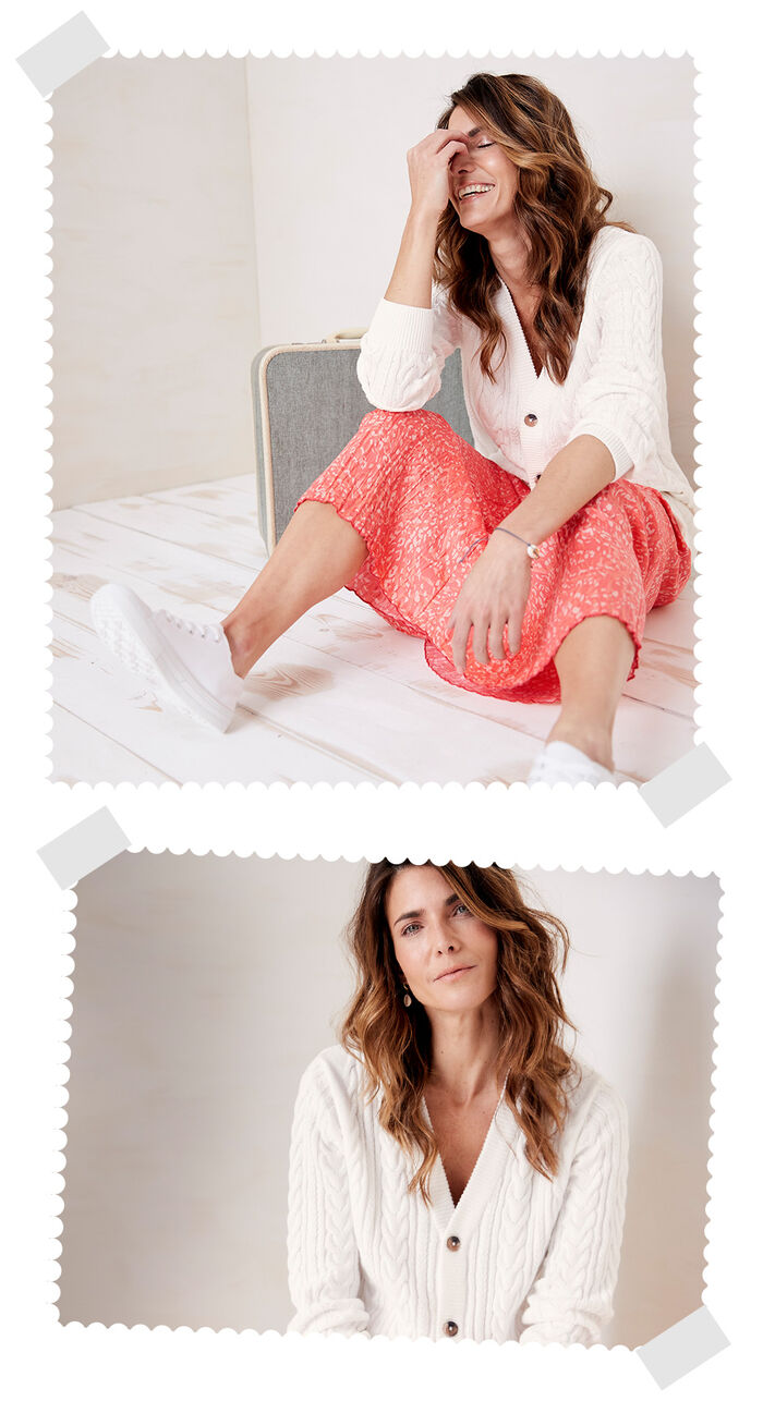 Two images of a woman sat on the floor in a white Cotton Traders kitted cardigan. In the first image she's laughing and in the second she's looking at the camera.